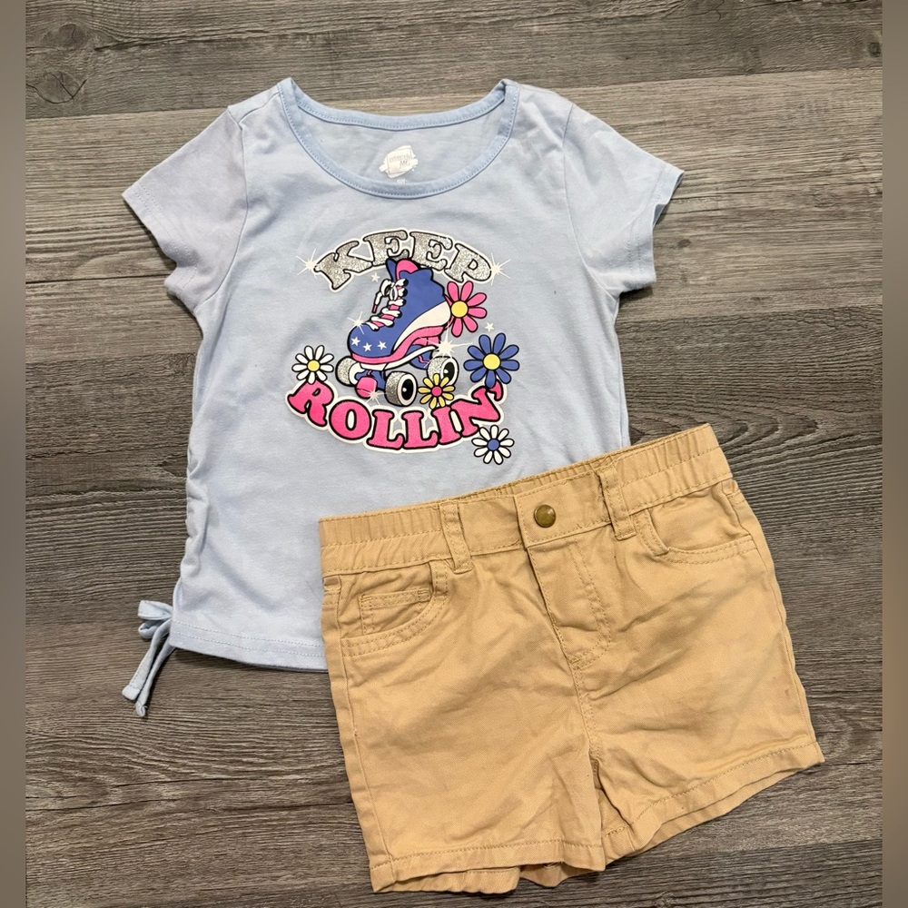 Light Blue 'Keep Rollin' Graphic Tee with Tan Shorts.
Girls size 5/6